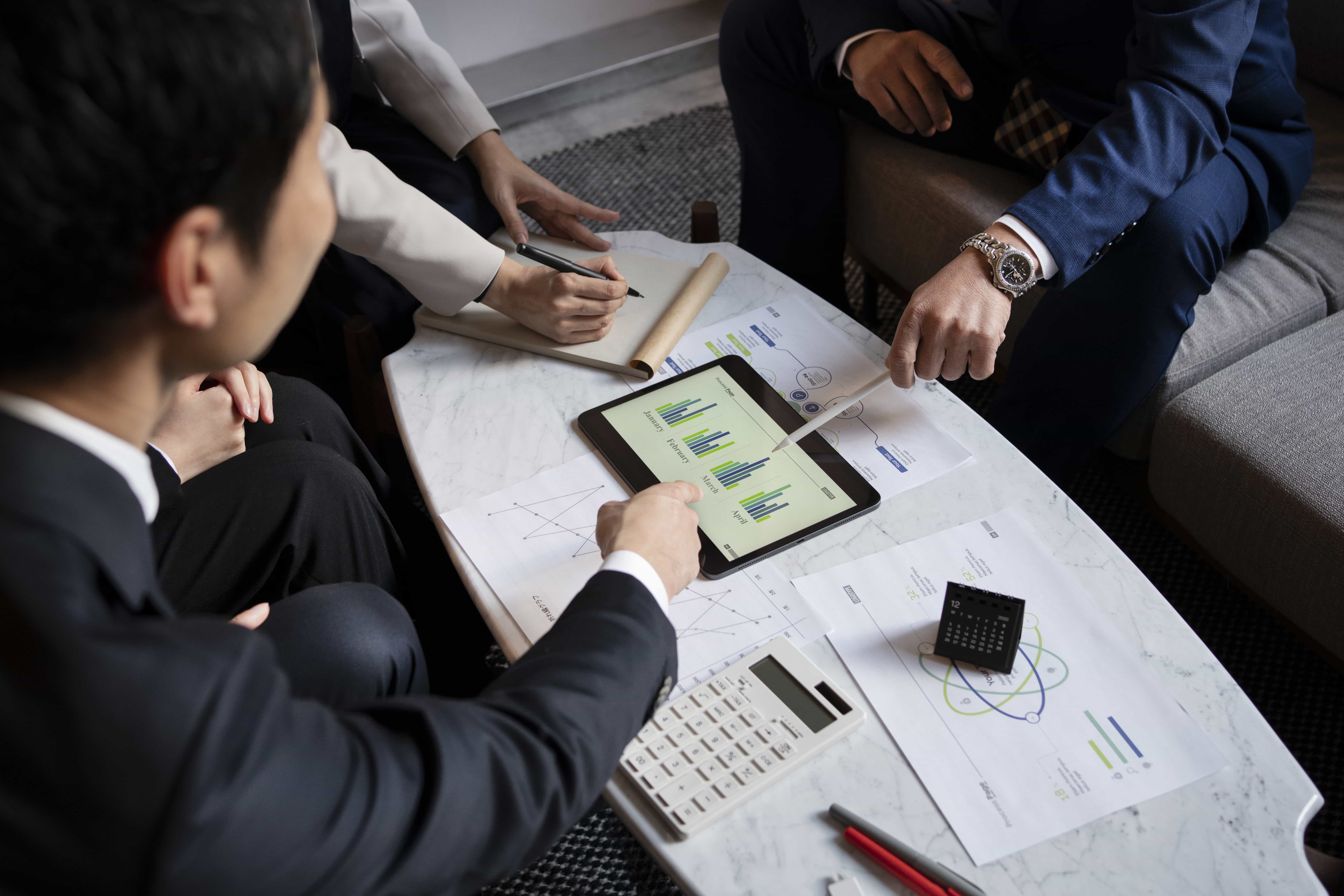 business people working with iPad high angle