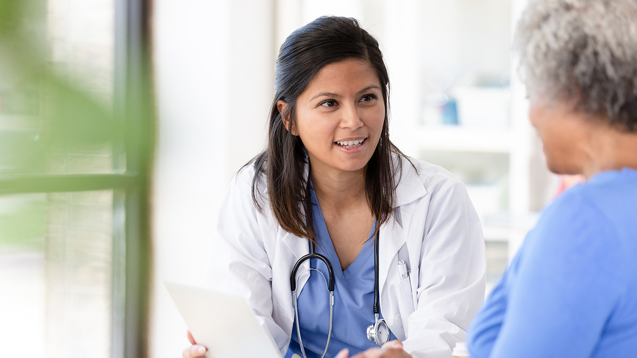 Female doctor checking on her older patient
