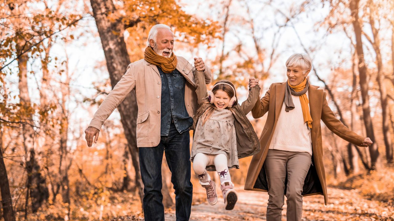 Grand parents carrying their granddaughter